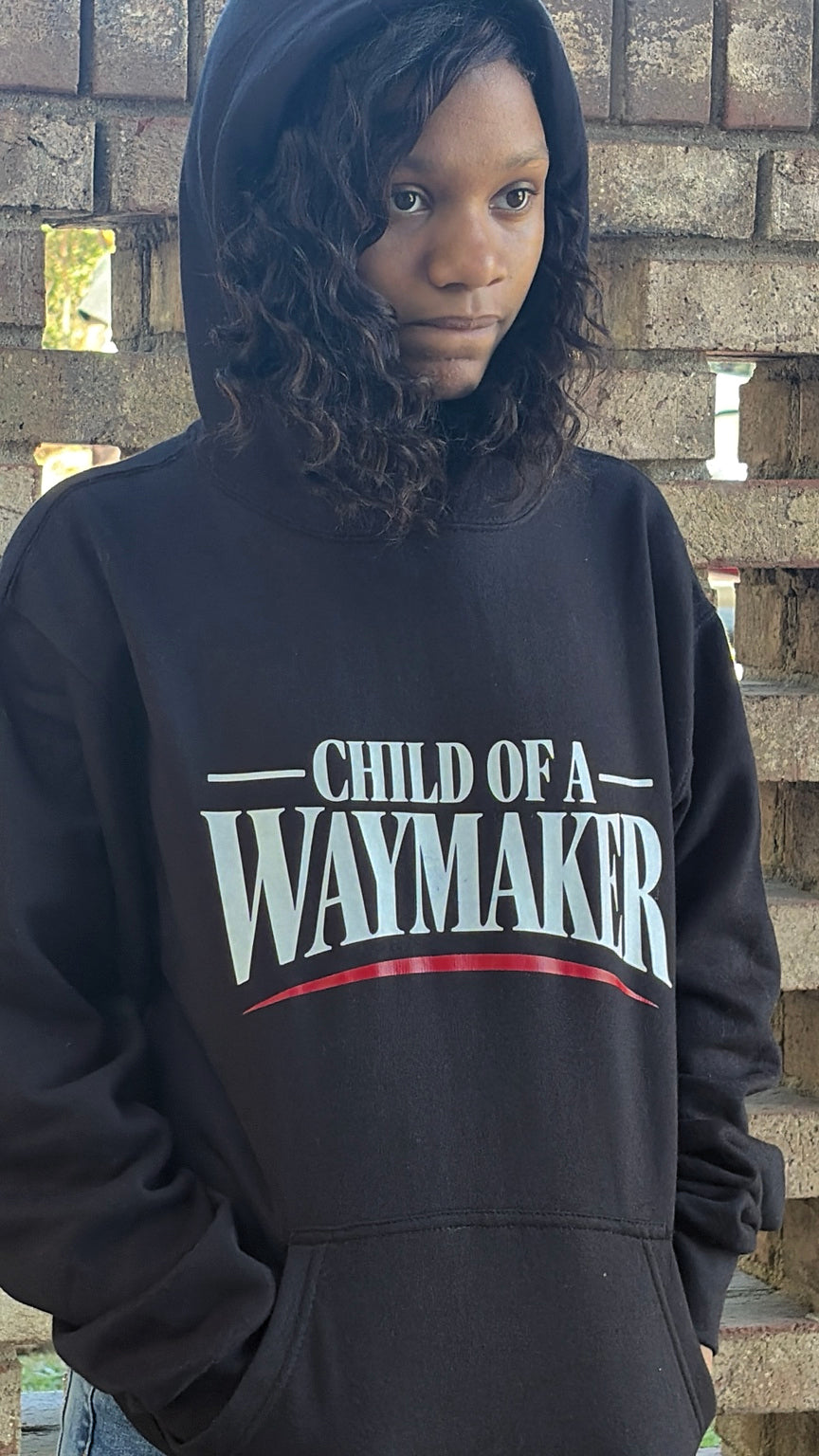 Black Child of a Waymaker hoodie, front lettering and fit on model